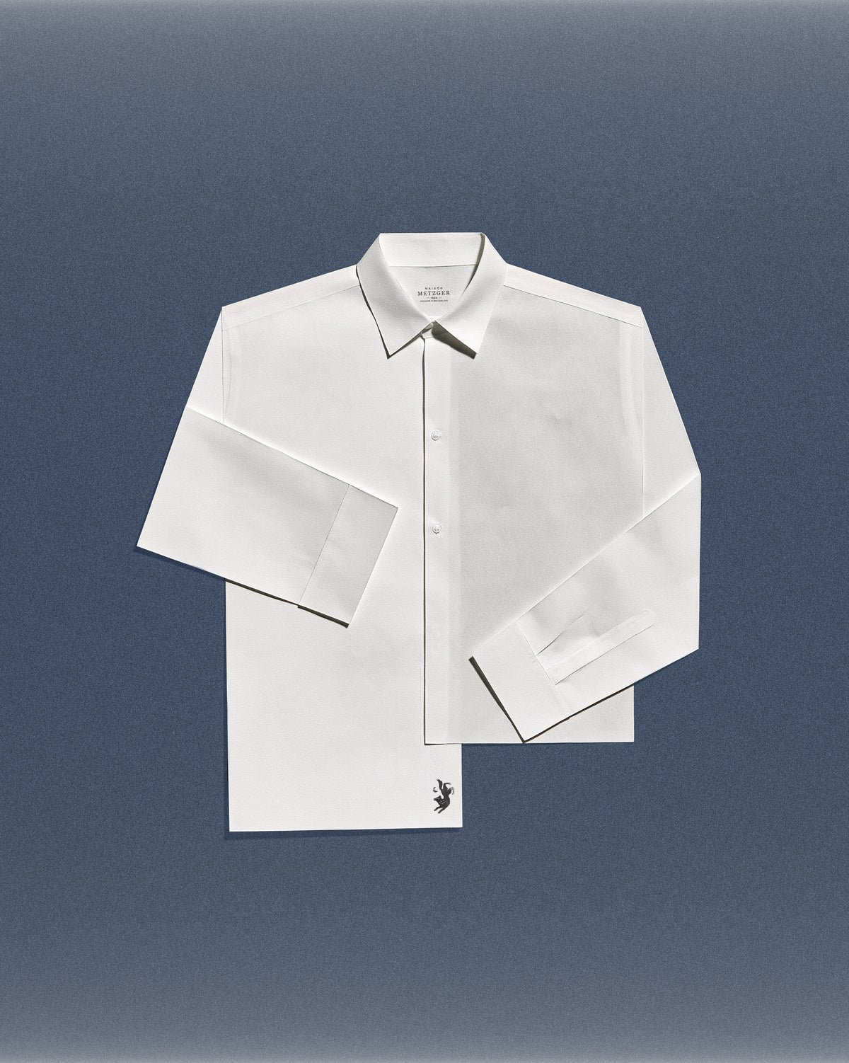 Maison Metzger white shirt on a blue background